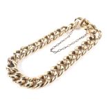 An 18ct gold curb link bracelet with safety chain links, stamped '18',