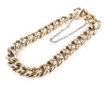 An 18ct gold curb link bracelet with safety chain links, stamped '18',