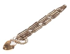 A 9ct rose gold gate bracelet with heart locket,