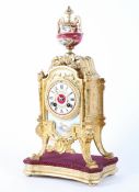 A French gilt metal and porcelain mounted eight day striking mantel clock on giltwood stand,