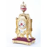 A French gilt metal and porcelain mounted eight day striking mantel clock on giltwood stand,