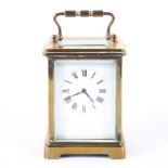 A French 20th century eight day brass carriage clock, the white enamelled dial with Roman numerals,