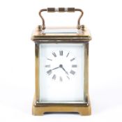 A French 20th century eight day brass carriage clock, the white enamelled dial with Roman numerals,