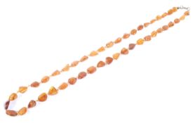 An amber polished beaded necklace with clasp 63cm long