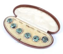 A boxed set of six dress buttons, each set with an iridescent green semi precious stone,