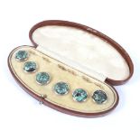 A boxed set of six dress buttons, each set with an iridescent green semi precious stone,