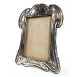 An Art Nouveau silver easel photograph frame, in the Tiffany style, makers mark rubbed, Chester,