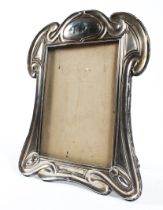An Art Nouveau silver easel photograph frame, in the Tiffany style, makers mark rubbed, Chester,