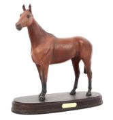 A large Beswick ceramic racehorse, named 'Arkel', mounted on wooden stand,