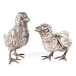 A pair of silver cruets in the form of chicks with removable heads,