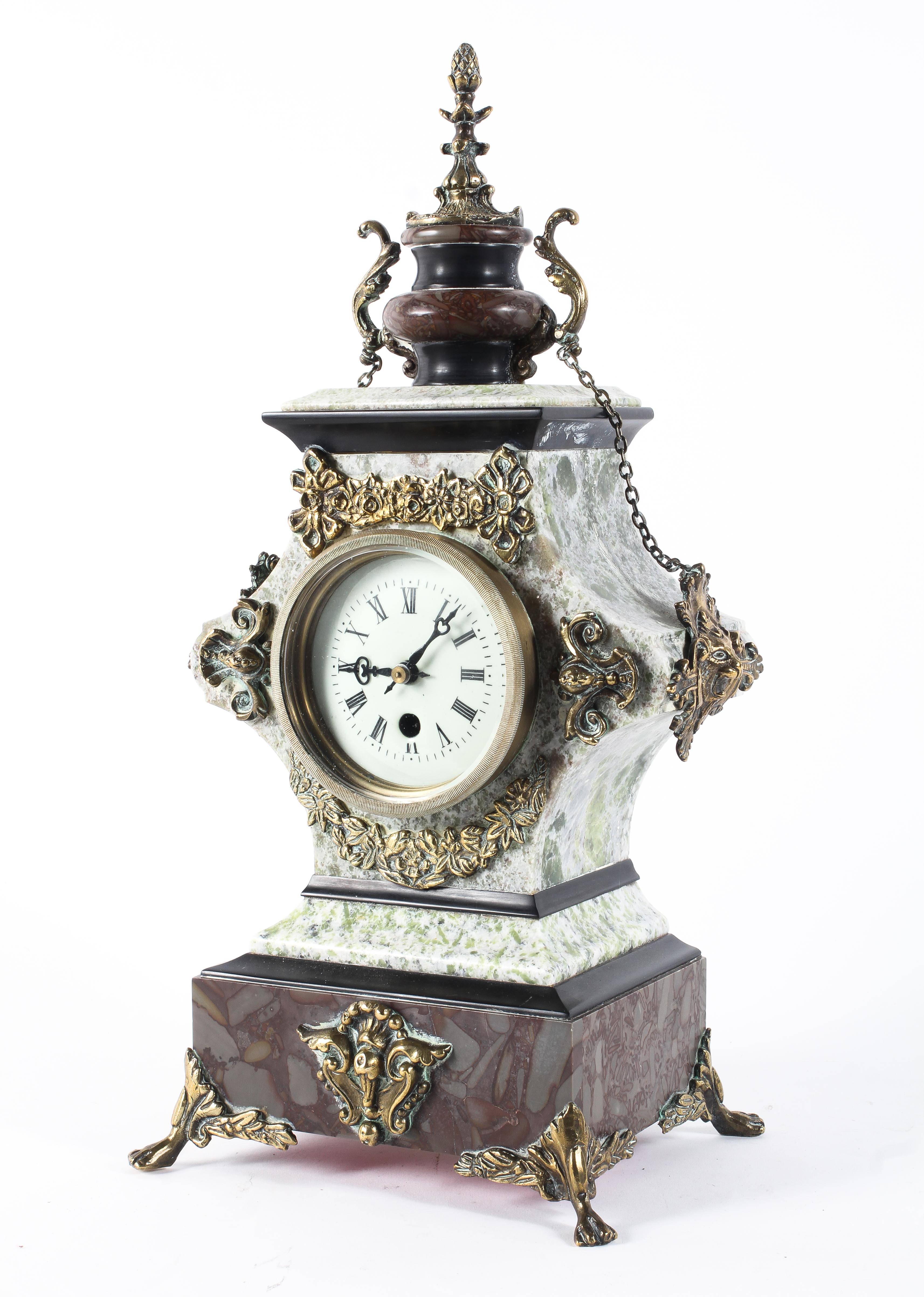 A late 19th century French brass, marble and stone mounted mantel clock,