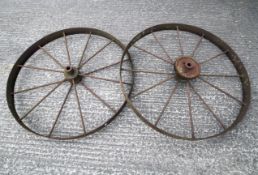 A pair of large cast iron wheels, cast with P45 mark to centre, 119cm diam.