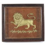 A late 19th century oak cased carved giltwood lion, the lion passant above a floral garland,