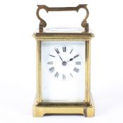 A brass carriage clock in a leather travelling case, early 20th century,