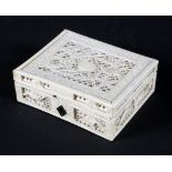 A late 19th/early 20th century Chinese carved ivory box, with frettwork panels of flowers,