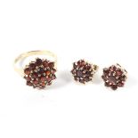 A 9ct gold garnet cluster dress ring and a pair of matching earring, size P.