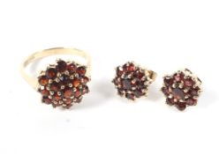 A 9ct gold garnet cluster dress ring and a pair of matching earring, size P.