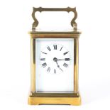 A 20th century brass eight day carriage clock, the white enamelled dial with Roman numerals,