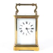 A 20th century brass eight day carriage clock, the white enamelled dial with Roman numerals,