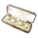 A cased set of four yellow metal shirt studs by Gowland Bros Ltd,