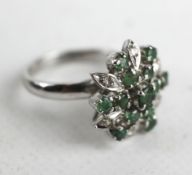 Unmarked white gold diamond and emerald flower ring,