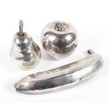 Three silver models of fruit, comprising a banana, pear and an apple, makers mark John Bull,