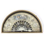 A late 18th century French folding fan, the heavy sticks carved, pierced and gilded,