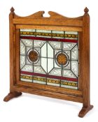 A Victorian Arts and Craft oak framed stained glass panel or screen,