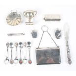 An assortment of silver, to include a ladies purse with fitted interior, flatware, vesta case,