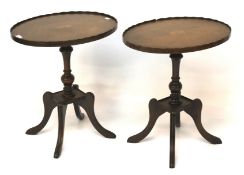 A pair of oval inlaid mahogany occasional tables.