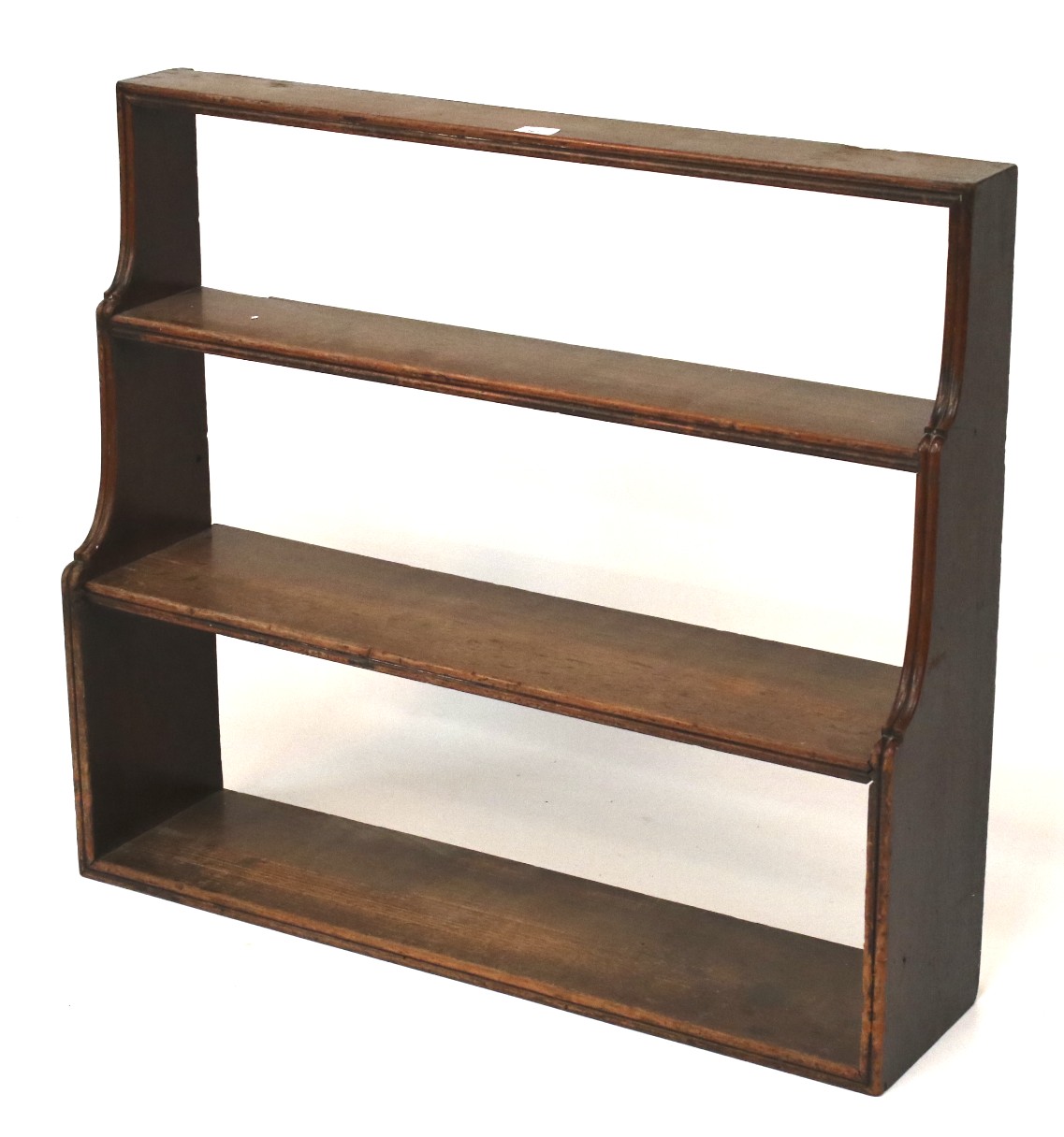 An early 20th century waterfall bookshelf of three tiers.