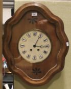 An oak cased wall clock with pendulum and key.