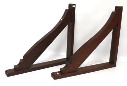 A pair of stainted wooden gallow brackets.