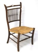 An Arts and Crafts style nursing chair with rush seat.