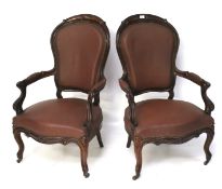 Two late 19th century mahogany framed serpentine shaped armchairs.