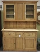 A large, early 20th century pine dresser in two sections.
