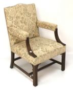 A mahogany framed upholstered armchair with fluted arms and raised on square supports.