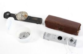 A disassembled Ernst Leitz Wetzlar FOKOS shoe mount rangefinder in leather case and an earlier