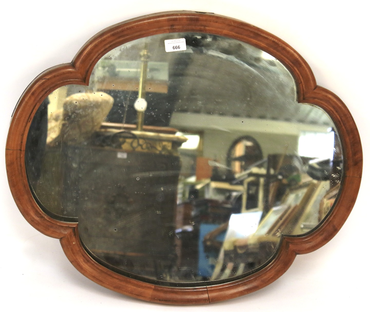 A Victorian mahogany quatrefoil framed wall mirror, with cushion shaped frame,