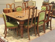 A mahogany dining table and eight chairs.