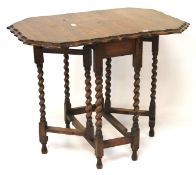A 1920s oak gateleg tea table. With scalloped edge and on barley twist supports.