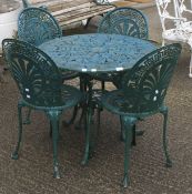 A green painted metal garden set of table and four chairs with pierced decoration.