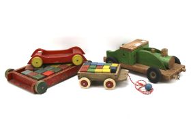 An assortment of wooden push-pull toys including Tri-ang