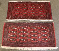 A pair of Turkaman small red ground rugs. Each woven with geometric lozenges and crosses.