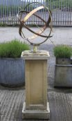 A copper and brass sun dial on a square stone pedestal.