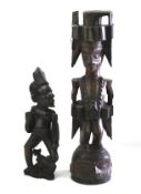 A native African wood carving of a tribal warrior and another of a man with a goat.