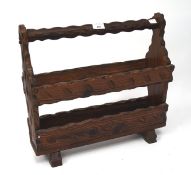 A 20th century carved wooden magazine rack.