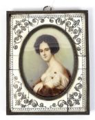 A 19th century portrait minature on ivory of a lady set in a carved ivory frame