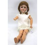 An early 20th century composite and bisque articulated doll.