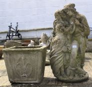 A composite stone ornament of a lady and man and a moulded square plant pot.